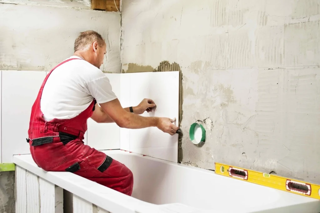 A professional from Builders Central Otago working on bathroom renovation Central Otago, installing tiles with precision.