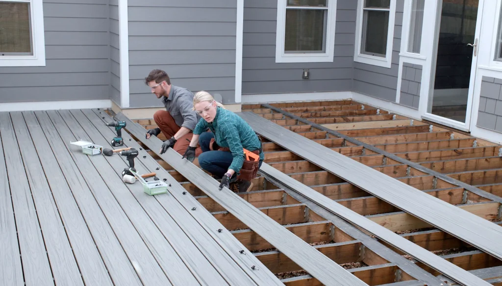 Couple expertly assembling a deck with Builders Central Otago, led by skilled Deck builders Central Otago.