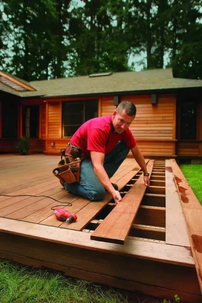 Craftsman installing timber boards, expertly done by Deck builders Central Otago at Builders Central Otago.